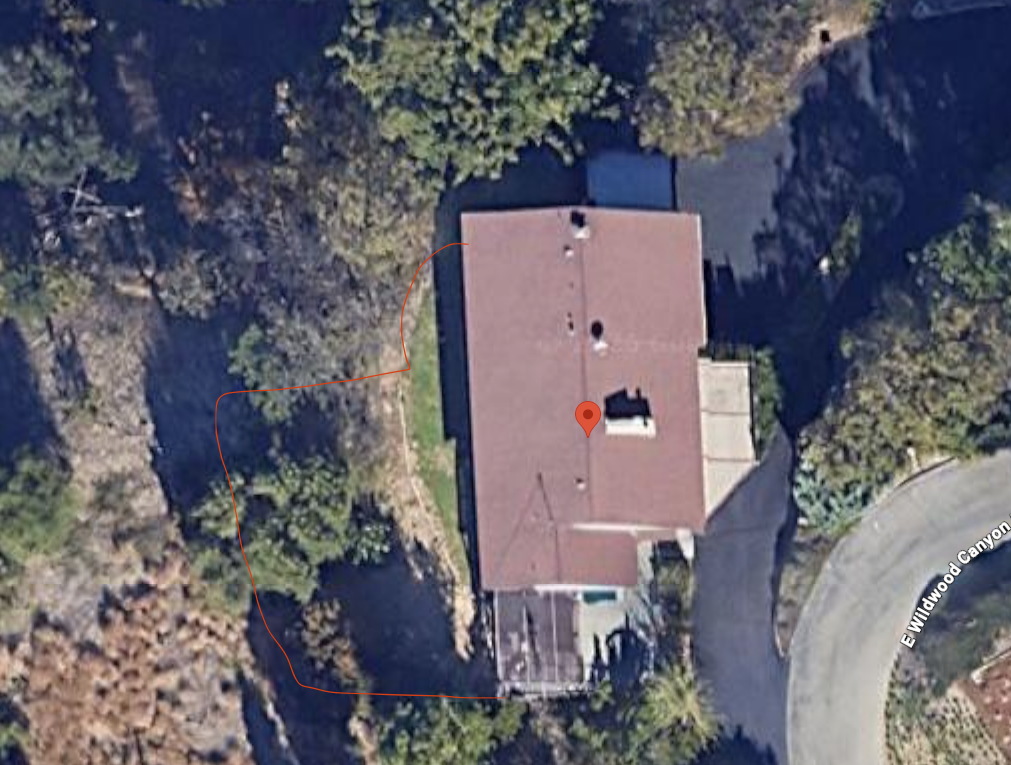 Aerial view of the property with the planned chain-link fence run marked in orange, forming a U along the west side, across the rear, and along the south edge.